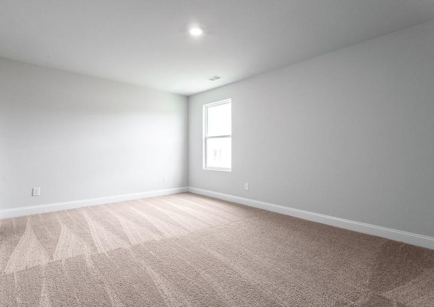 Secondary bedroom with carpet.