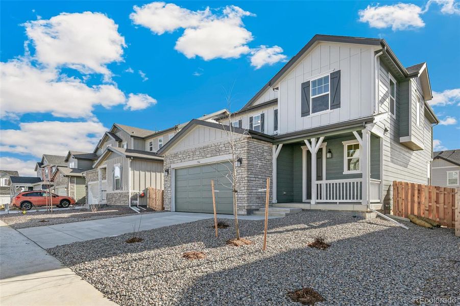 Front exterior of a new home in Turnberry, Commerce City, CO, highlighting curb appeal (Image 21).