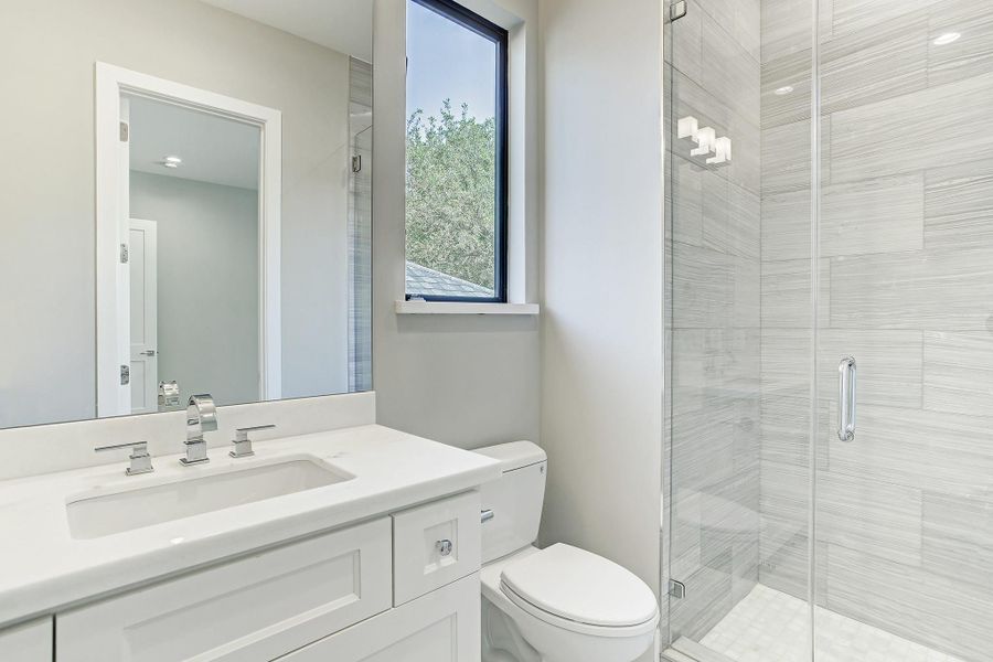 One of 4 full bathrooms elegantly appointed with designer selected counters, beautiful tiled wall to the ceiling and Baldwin hardware. One of 4 full bathrooms elegantly appointed with designer selected counters, beautiful tiled wall to the ceiling and Baldwin hardware.