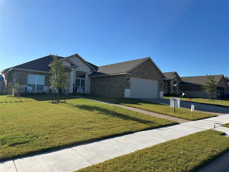 Single-story residence featuring a brick and stone facade Single-story residence featuring a brick and stone facade