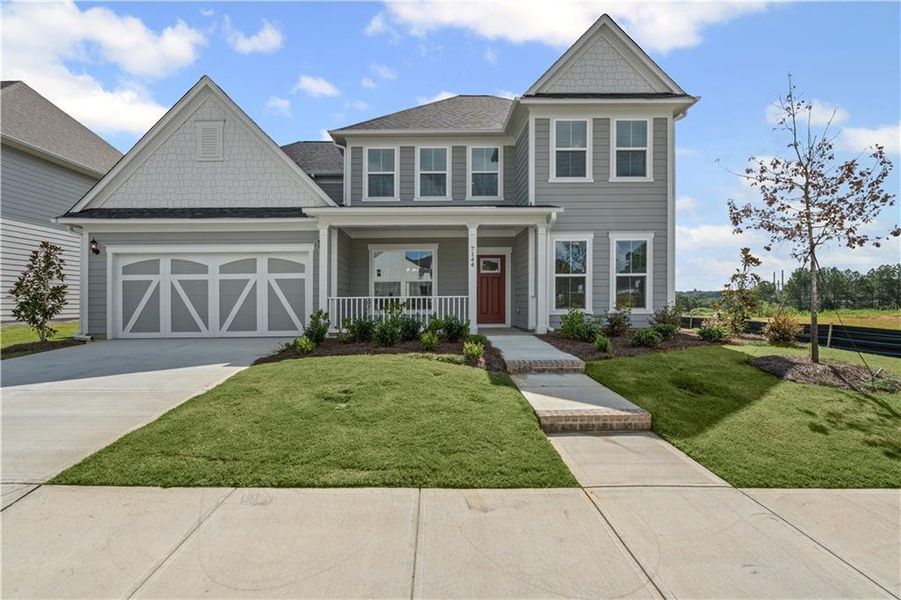 Front exterior of a new home in Reunion, Flowery Branch, GA, highlighting curb appeal (Image 2). Front exterior of a new home in Reunion, Flowery Branch, GA, highlighting curb appeal (Image 2).