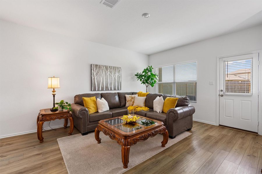Living area featuring light wood-style flooring and baseboards