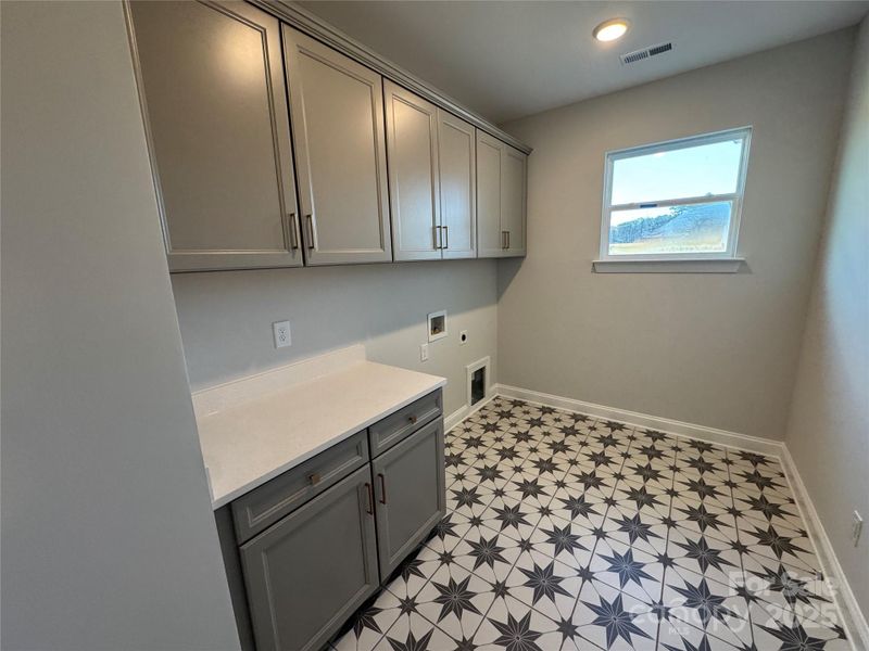 Large laundry room with built-in cabinetry