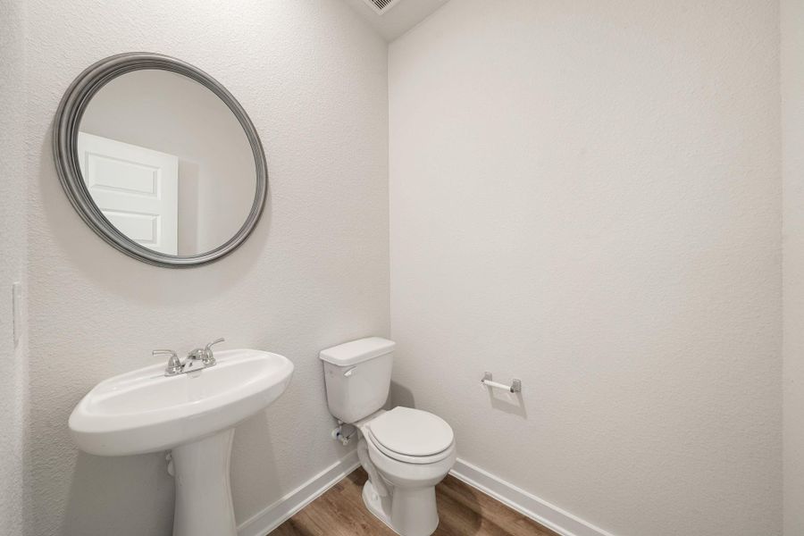 This powder room offers a clean and modern design with neutral tones, a pedestal sink, and elegant fixtures—ideal for guests and everyday convenience. This powder room offers a clean and modern design with neutral tones, a pedestal sink, and elegant fixtures—ideal for guests and everyday convenience.
