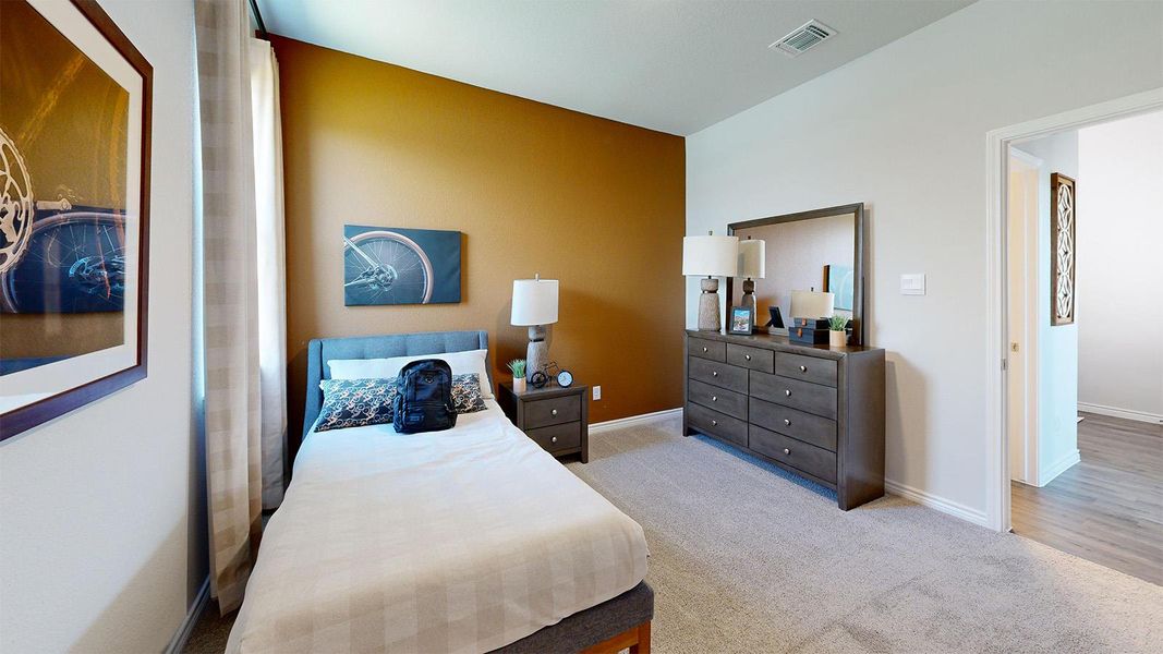 Bedroom featuring light carpet and baseboards Bedroom featuring light carpet and baseboards