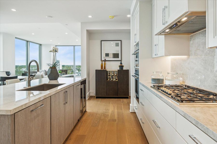 Alternate view of the kitchen with gorgeous porcelain counter-top and a space for a future built-in bar Alternate view of the kitchen with gorgeous porcelain counter-top and a space for a future built-in bar