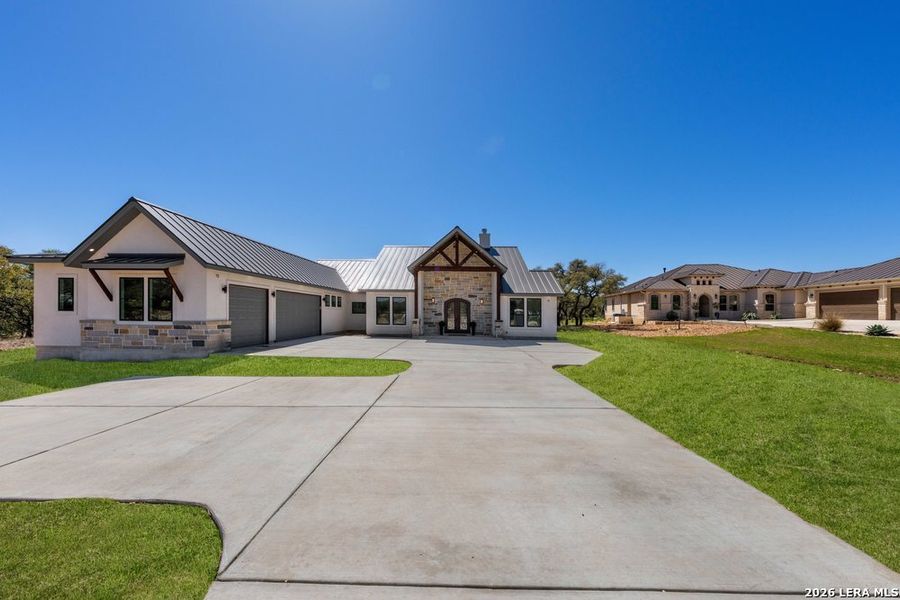 Front exterior of a new home in , Bulverde, TX, highlighting curb appeal (Image 26).