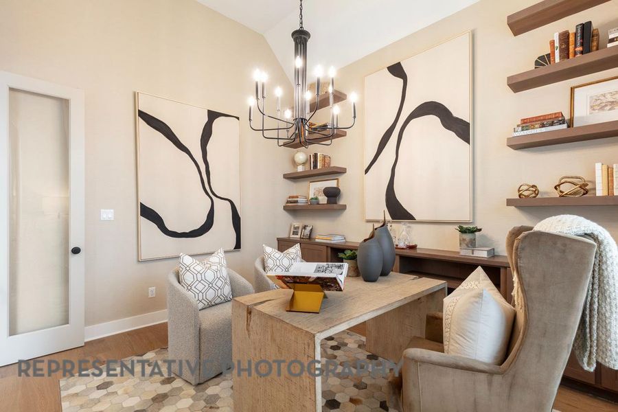 Living area with a chandelier, wood finished floors, lofted ceiling, and baseboards Living area with a chandelier, wood finished floors, lofted ceiling, and baseboards