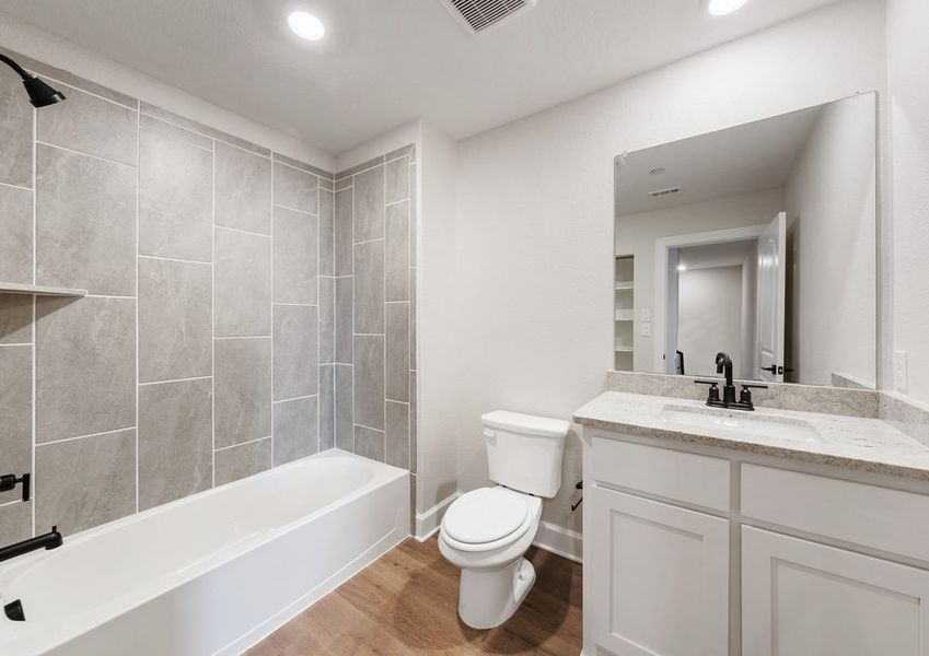 The secondary bathroom has a wonderful vanity space and shower-tub combo.