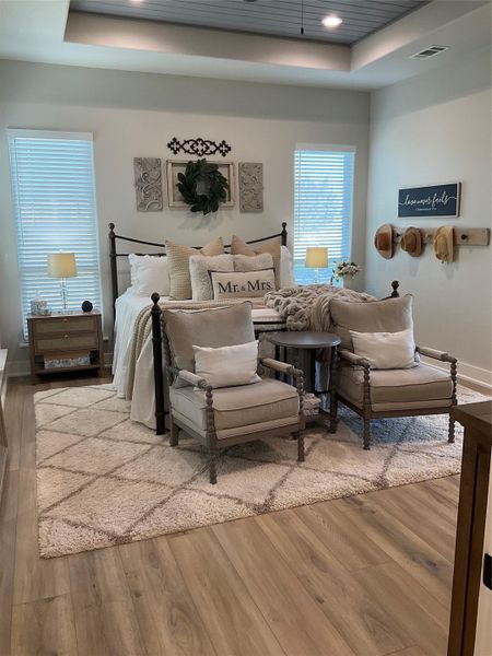 recessed can lights, LVP floors, custom tray ceiling with wood and fan