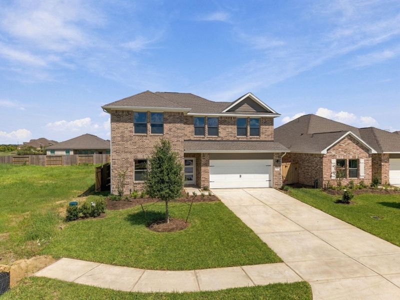 Front exterior of a new home in Windrose Green, Angleton, TX, highlighting curb appeal (Image 20). Front exterior of a new home in Windrose Green, Angleton, TX, highlighting curb appeal (Image 20).