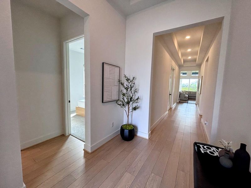 Bright, spacious hallway, recessed lighting, and modern decor.