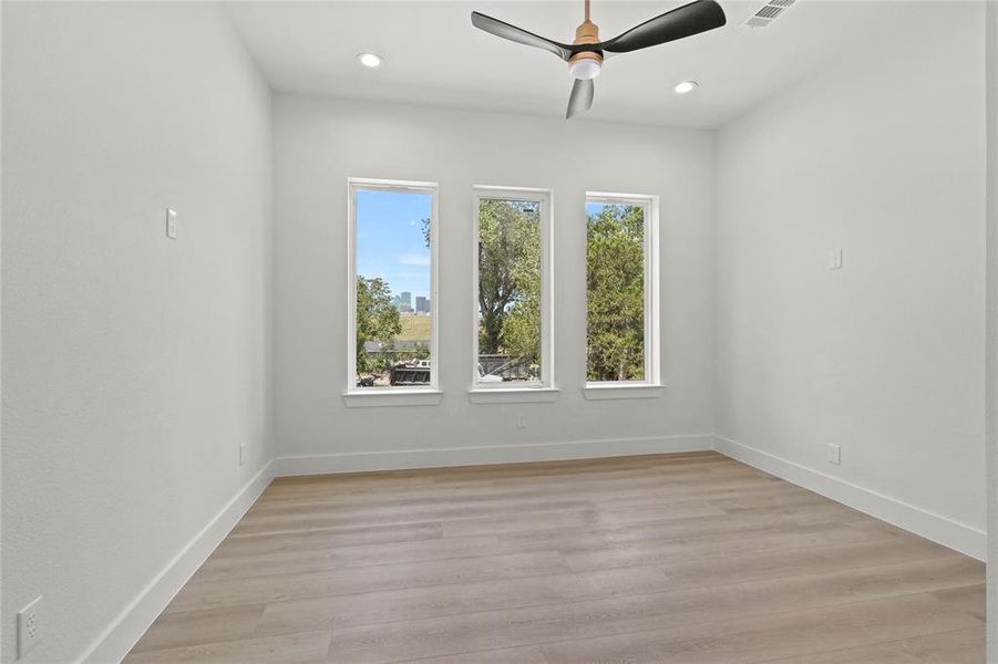 Spare room featuring light hardwood / wood-style floors and ceiling fan