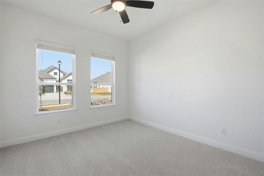 Bright interior room featuring neutral carpeting and white walls