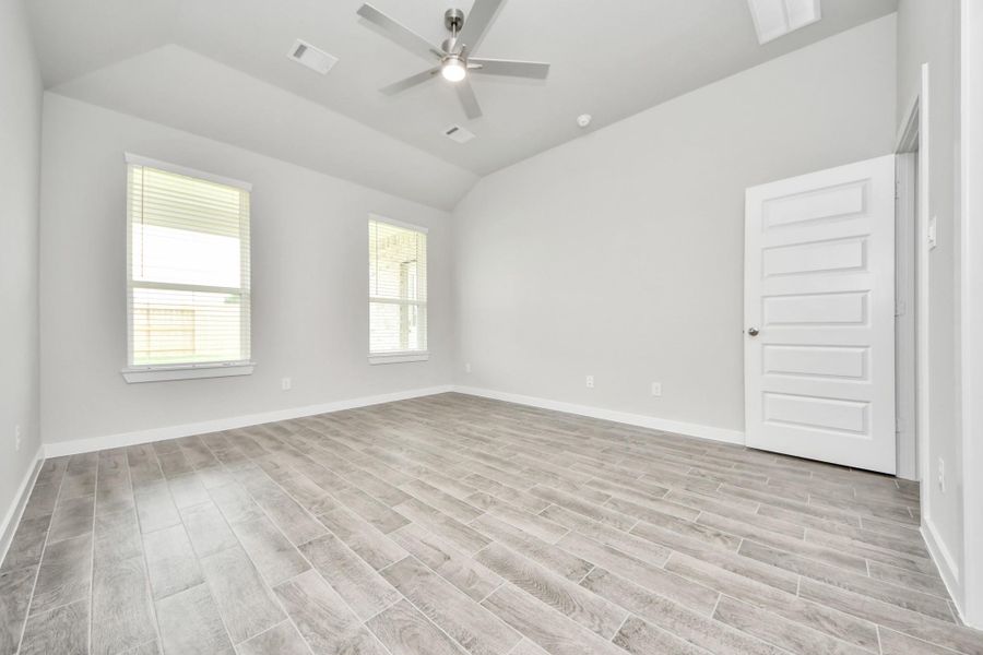 Retreat to the luxurious primary suite, your perfect escape for unwinding after a long day. Sample photo of completed home with similar floor plan. Actual colors and selections may vary.