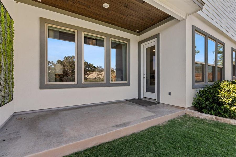 A wood accent ceiling and recessed lighting on the roomy covered back patio.