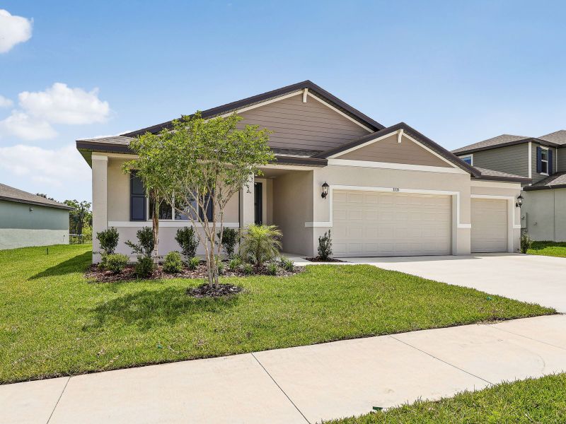 Front exterior of a new home in The Grove at Stuart Crossing - Signature Series, Bartow, FL, highlighting curb appeal (Image 2). Front exterior of a new home in The Grove at Stuart Crossing - Signature Series, Bartow, FL, highlighting curb appeal (Image 2).