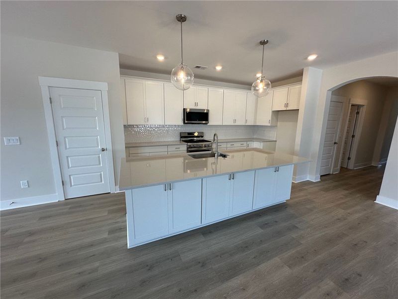 This bright kitchen features an island, ample coun