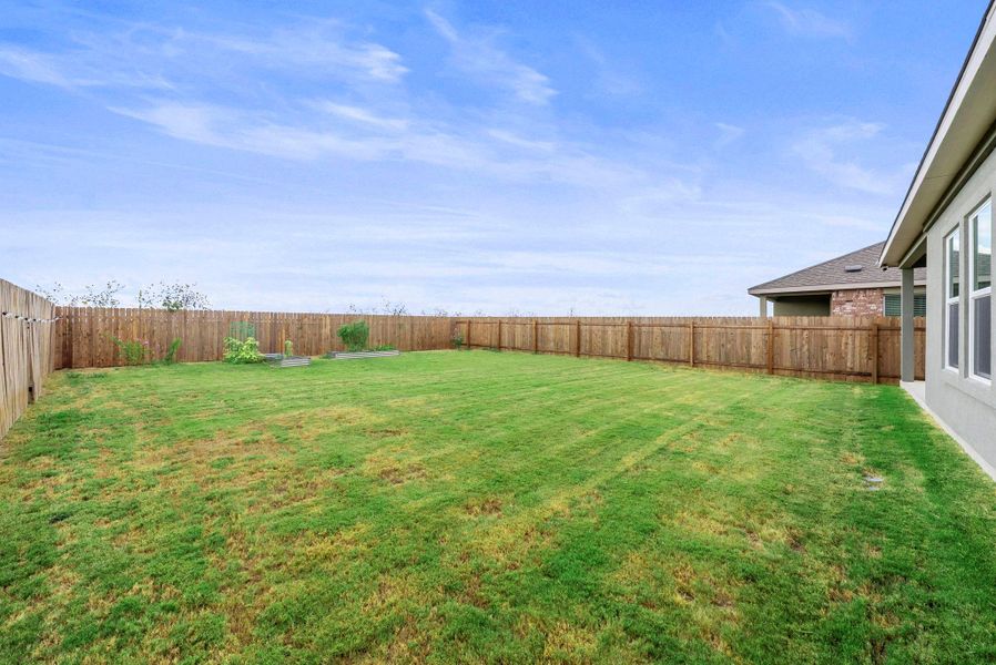 A generously sized yard, fully fenced for privacy, awaits your personal landscaping touches. A generously sized yard, fully fenced for privacy, awaits your personal landscaping touches.