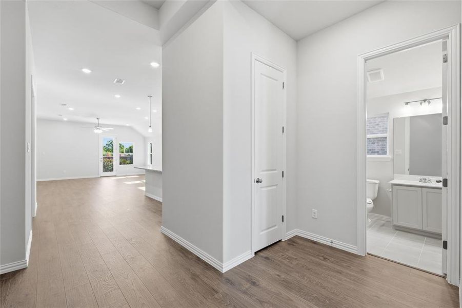 Hallway with recessed lighting and dark wood-style flooring Hallway with recessed lighting and dark wood-style flooring