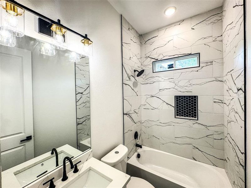 Bathroom featuring toilet, washtub / shower combination, and vanity Bathroom featuring toilet, washtub / shower combination, and vanity