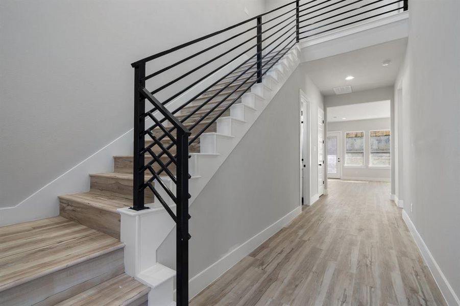 Stairway featuring wood-type flooring