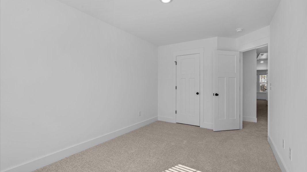 First-rate secondary bedroom with a spacious walk-in closet and elegant carpeted flooring
