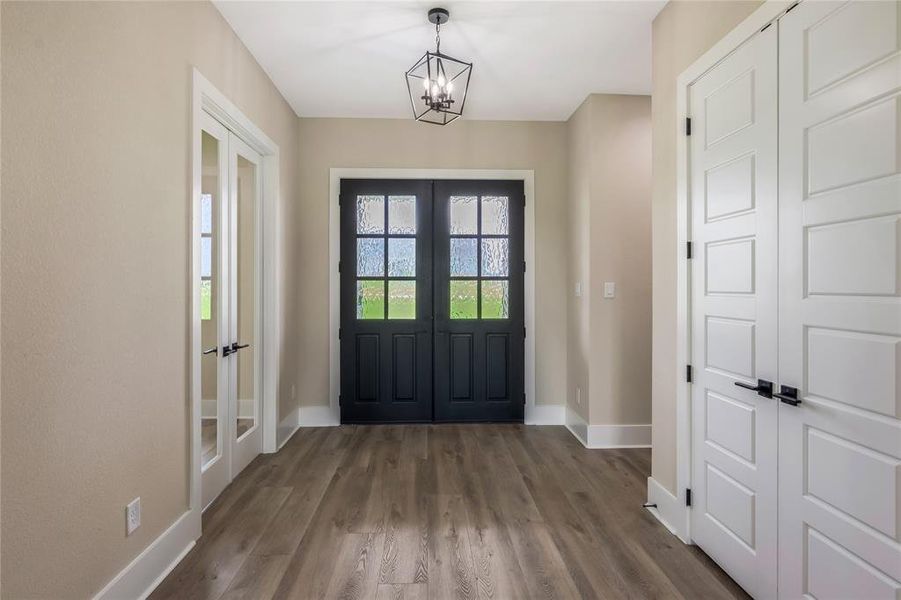 Entryway into the home, study is on the left, hallway leads to the secondary bedrooms Entryway into the home, study is on the left, hallway leads to the secondary bedrooms