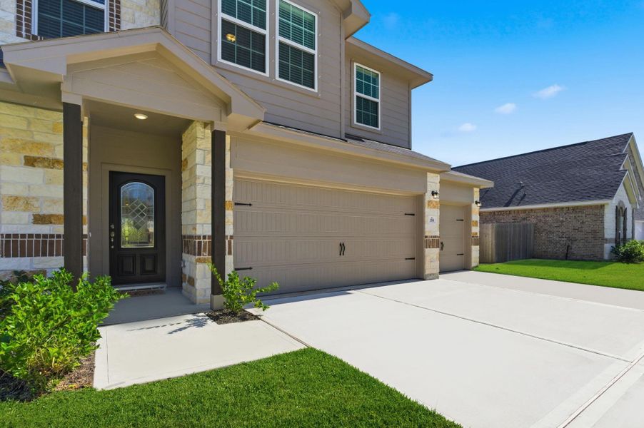A closer look at the inviting front entryway, showcasing the elegant covered porch and detailed stonework that add warmth and style. Step inside and experience the craftsmanship and attention to detail that make this home truly special.  Start your memories today and make that call!
