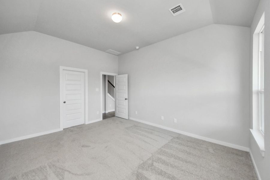 Come and unwind after a long day in this magnificent primary suite! This spacious room features plush carpet, warm paint, high ceilings and large windows with privacy blinds. Sample photo of completed home with similar floor plan. Actual colors and selections may vary.