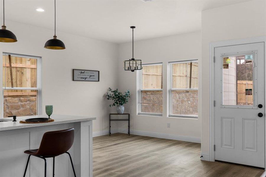 Dining space featuring hardwood / wood-style floors and an inviting chandelier