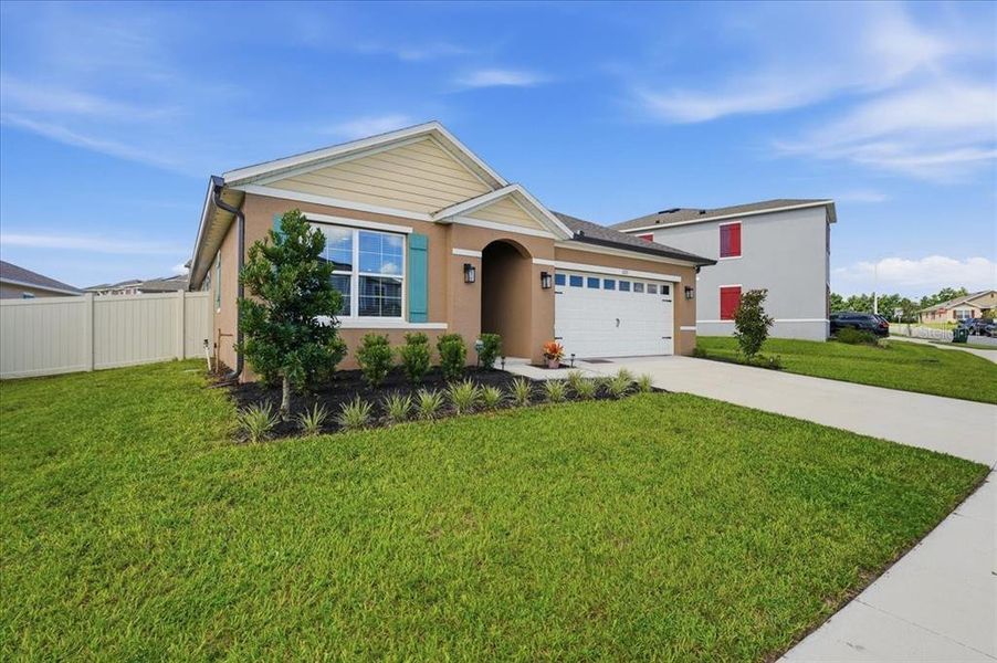Front exterior of a new home in Eden Hills, Lake Alfred, FL, highlighting curb appeal (Image 21).