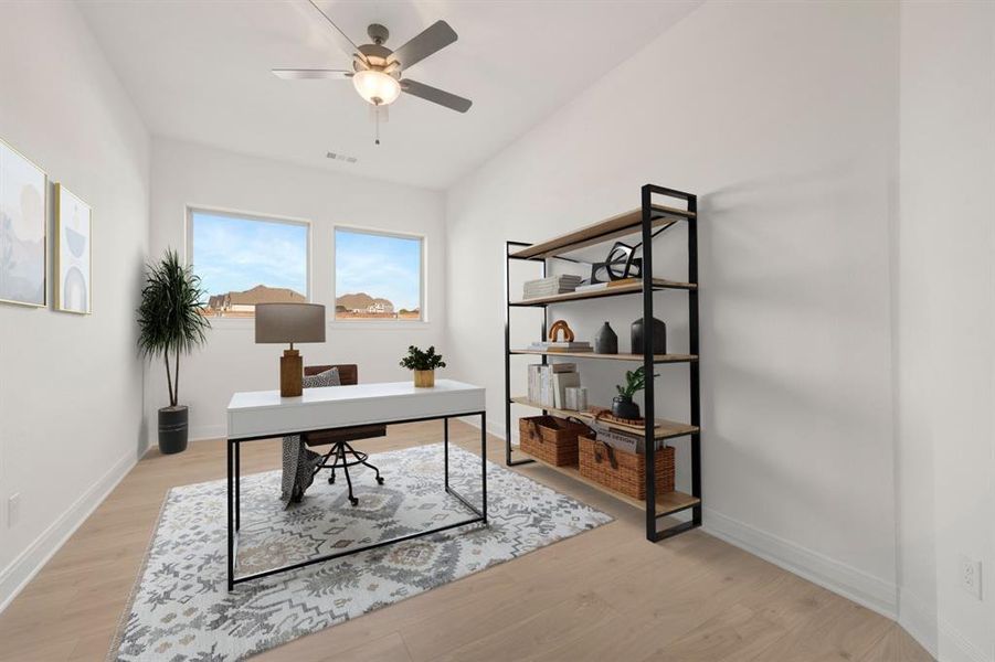 Dedicated interior space featuring wood-finish flooring and a contemporary ceiling fan Dedicated interior space featuring wood-finish flooring and a contemporary ceiling fan