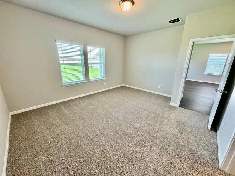 Carpeted empty room with baseboards Carpeted empty room with baseboards
