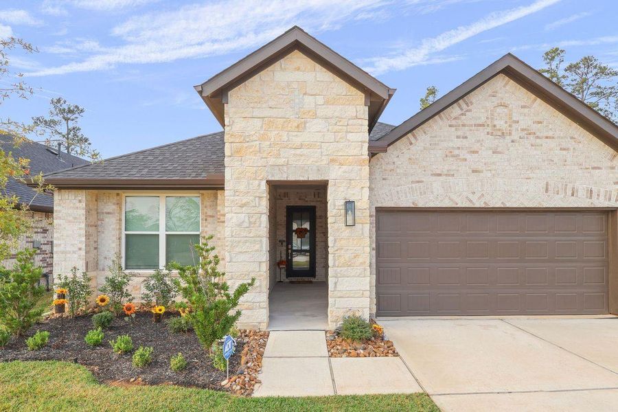 Front exterior of a new home in Hills of Westlake, Conroe, TX, highlighting curb appeal (Image 18).