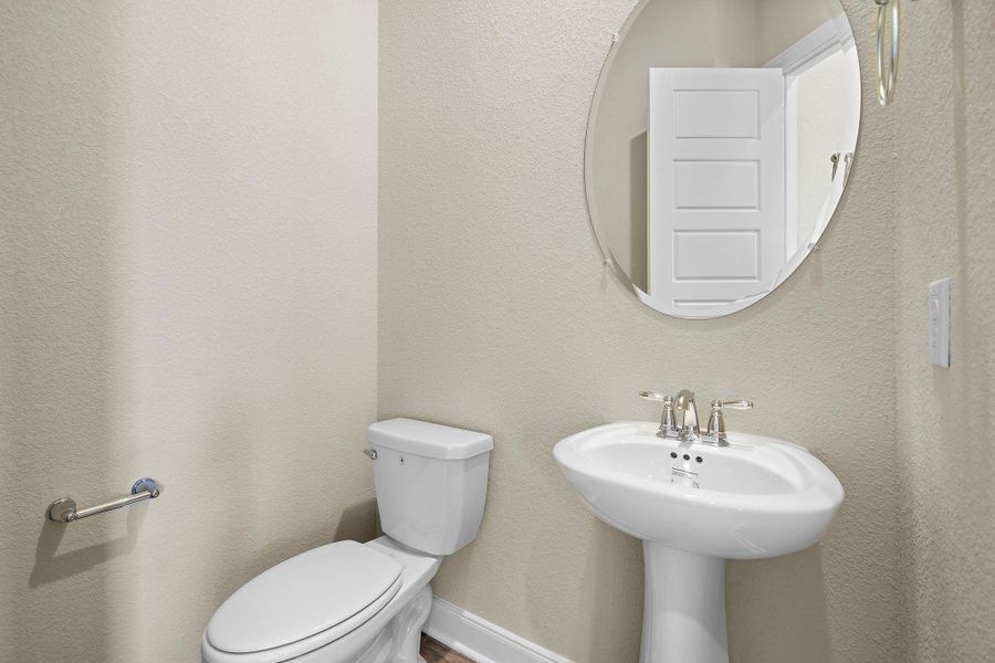 This sleek and stylish half-bath features a modern design, ideal for guests and conveniently located on the main floor. This sleek and stylish half-bath features a modern design, ideal for guests and conveniently located on the main floor.