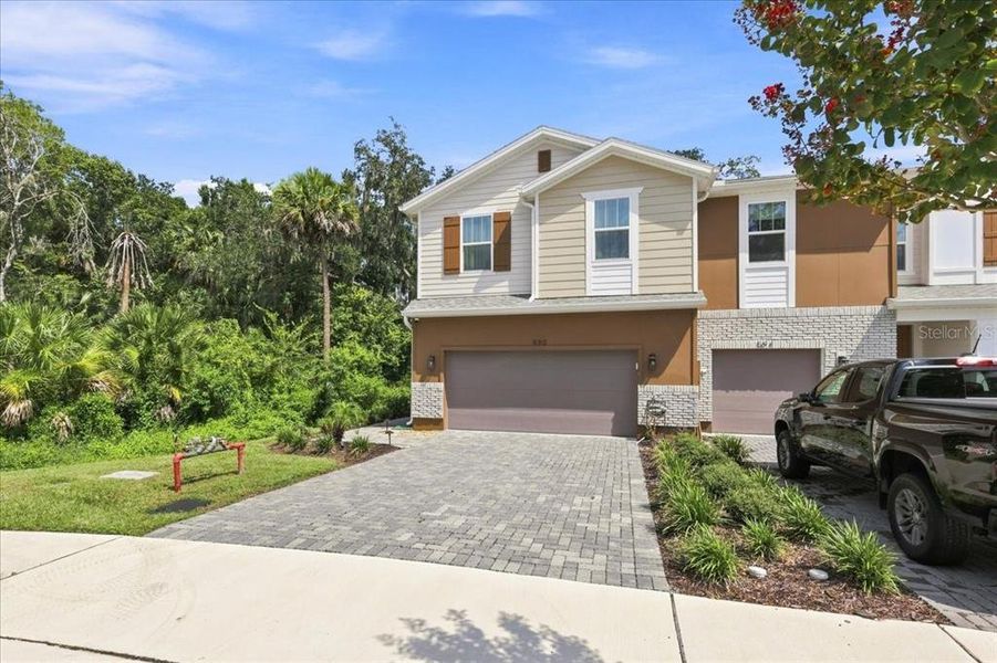 Front exterior of a new home in Towns at Riverwalk, Sanford, FL, highlighting curb appeal (Image 21). Front exterior of a new home in Towns at Riverwalk, Sanford, FL, highlighting curb appeal (Image 21).