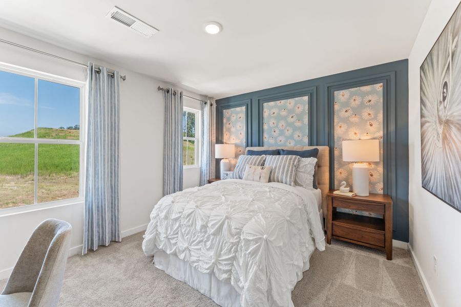 A bedroom with a bed and a window. A bedroom with a bed and a window.