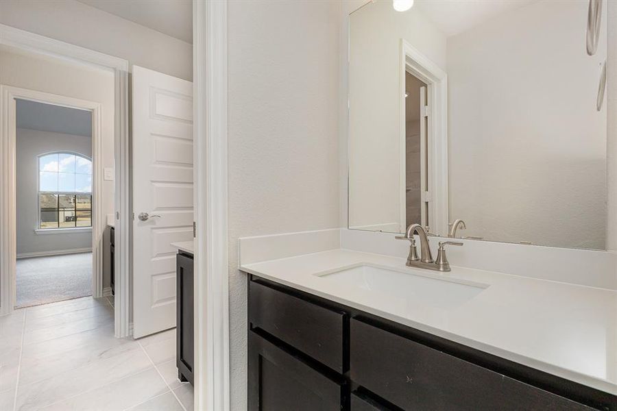 Bathroom with tile patterned flooring and vanity