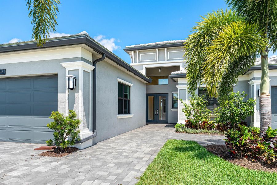 Front exterior of a new home in Valencia Grand, Boynton Beach, FL, highlighting curb appeal (Image 21). Front exterior of a new home in Valencia Grand, Boynton Beach, FL, highlighting curb appeal (Image 21).