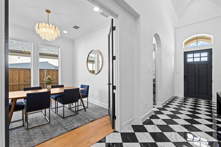 Entryway with crown molding, a chandelier, dark wood-style floors, recessed lighting, and a towering ceiling Entryway with crown molding, a chandelier, dark wood-style floors, recessed lighting, and a towering ceiling
