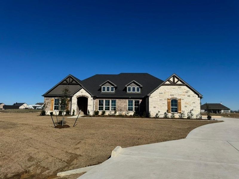 Front exterior of a new home in Rocky Top, Krum, TX, highlighting curb appeal (Image 13).