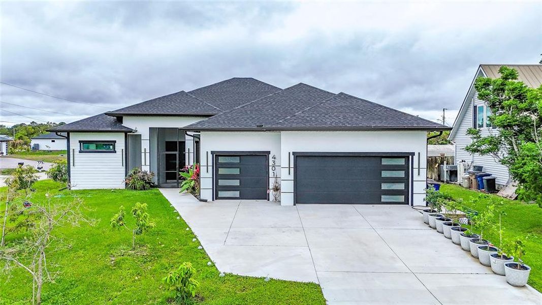 Front exterior of a new home in , Lehigh Acres, FL, highlighting curb appeal (Image 27).