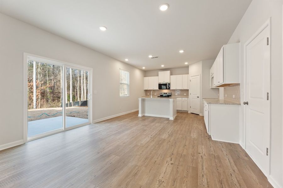 A large kitchen with white cabinets.