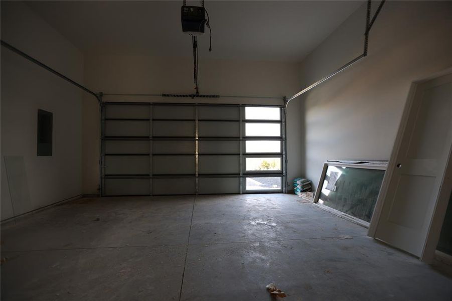 Garage with a garage door opener and electric panel Garage with a garage door opener and electric panel