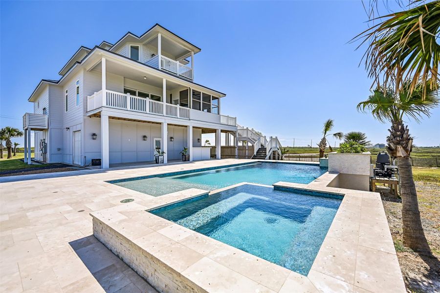 The pool steals the show: 32,000 gallons of saltwater with spa, waterfalls, and bubblers, surrounded by a travertine deck. Outdoor entertaining, sun-soaked afternoons, or quiet evenings under the stars—the perfect blend of relaxation and luxury.