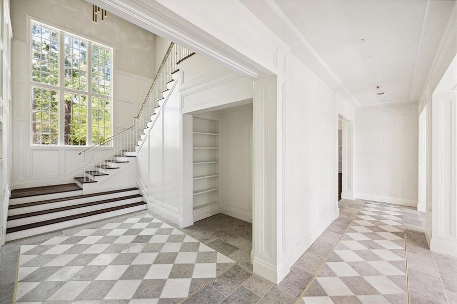 As you venture into the home, you are greeted by the handsome staircase to the second floor.