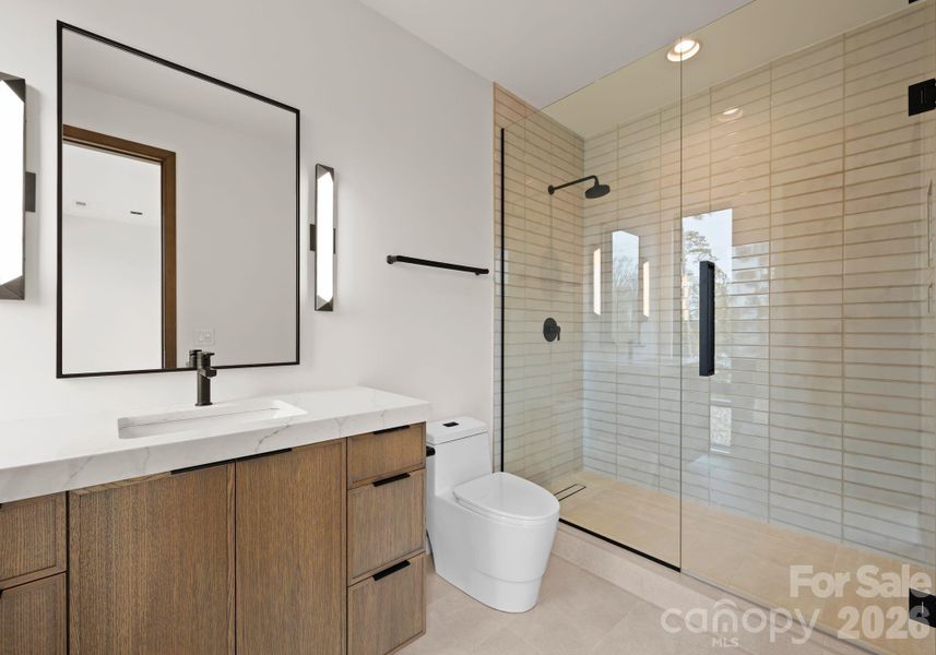 Guest suite with full bathroom and spacious walk-in closet. Guest suite with full bathroom and spacious walk-in closet.