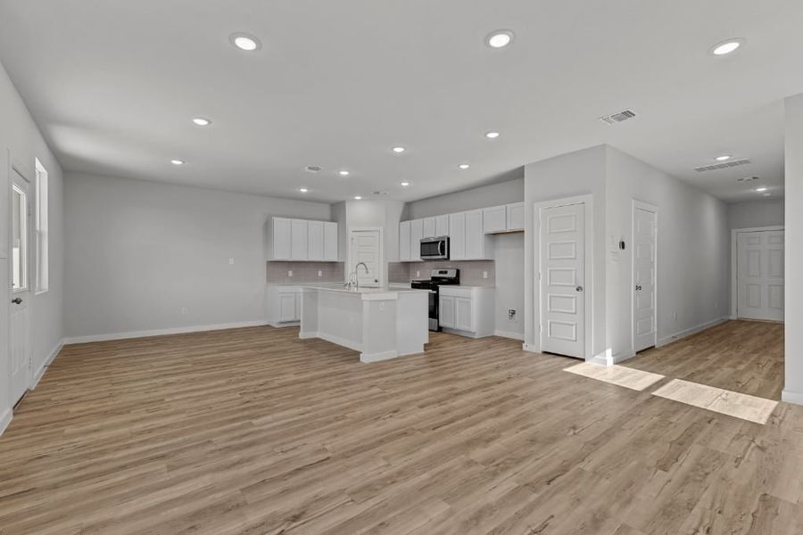 A large kitchen with white cabinets. A large kitchen with white cabinets.