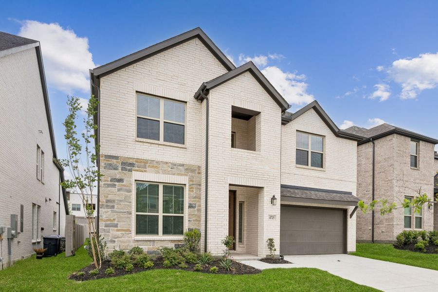 Front exterior of a new home in Painted Tree Woodland West, McKinney, TX, highlighting curb appeal (Image 22). Front exterior of a new home in Painted Tree Woodland West, McKinney, TX, highlighting curb appeal (Image 22).
